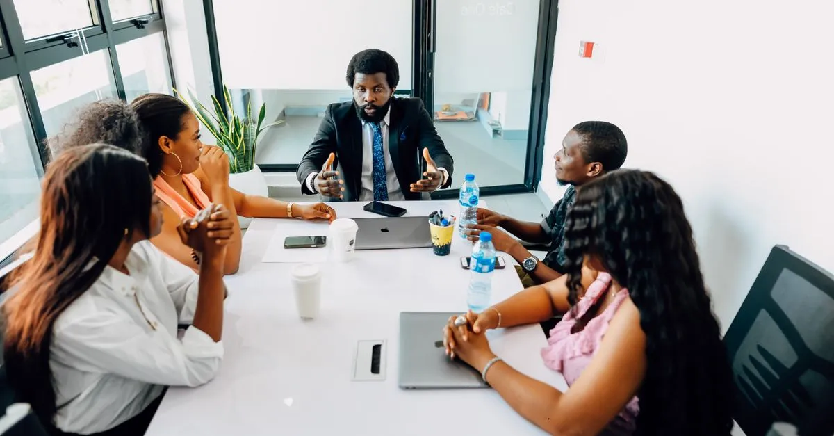 Business team gathered around a screen reviewing integrated notes and automated meeting summaries.
