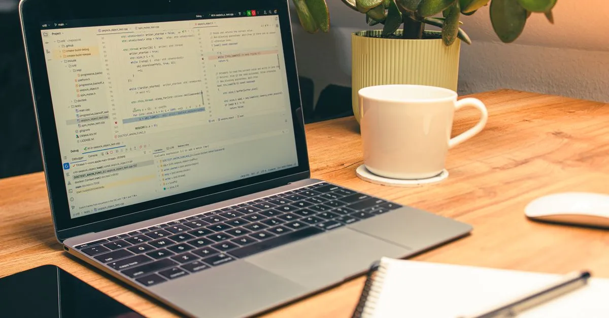 Professional wearing headphones at a computer, automatically turning an online meeting video into text.