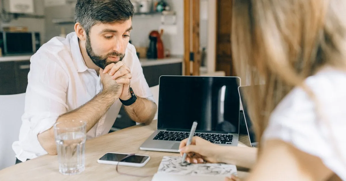 Casal analisando condições de usar imóvel alugado como garantia de empréstimo na sala de casa.